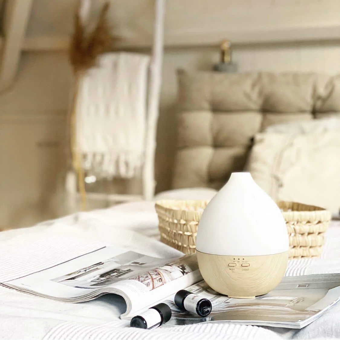 A Smellacloud aroma diffuser next to bottles of essential oil