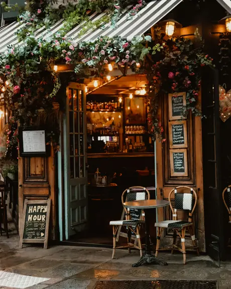 A cafe storefront hung with flowers