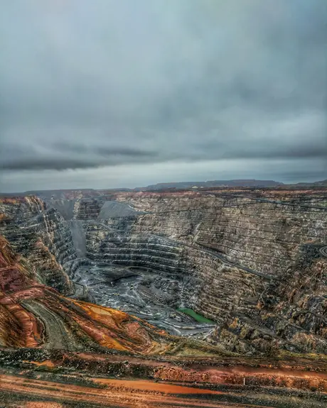 An open-pit mine under grey cloud
