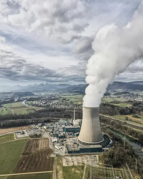 A power-station cooling tower among farmland